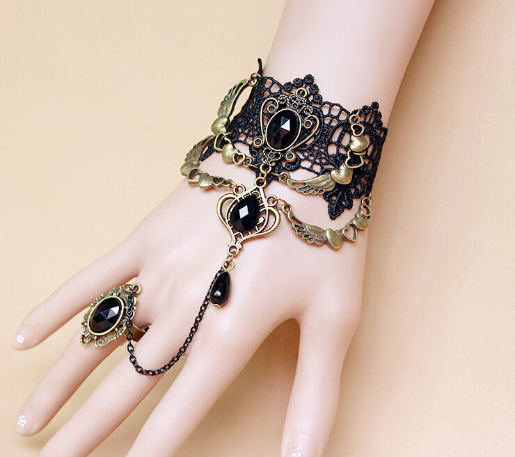 A mannequin's hand adorned with a Vintage Black Lace Bracelet and Ring from Maramalive™ exudes a touch of Gothic glamour.