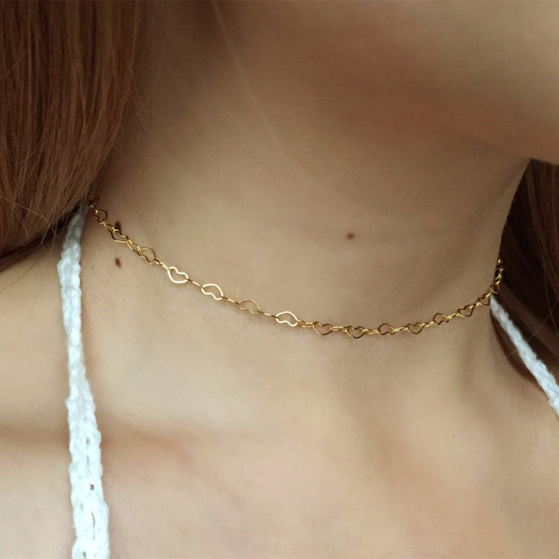 A woman wearing the Maramalive™ Women's Fashionable All-match Copper Heart-shaped Clavicle Necklace.