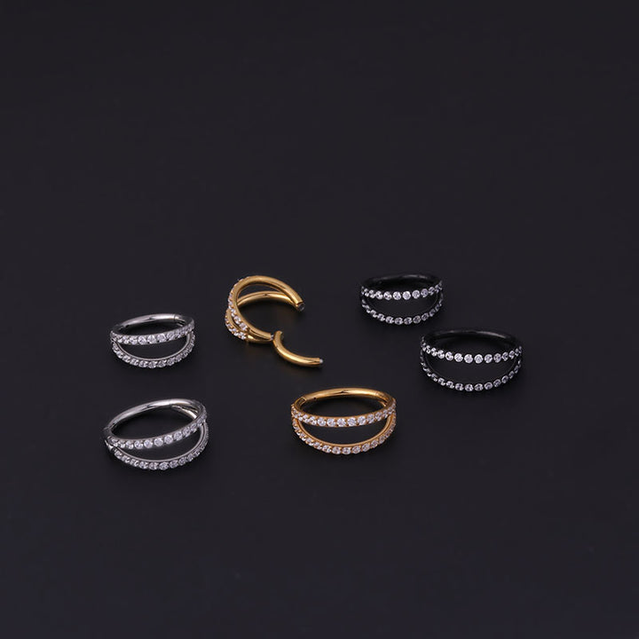 A set of Maramalive™ Stainless Steel Double Row Carved Zircon Seamless Nose Rings on a black surface.