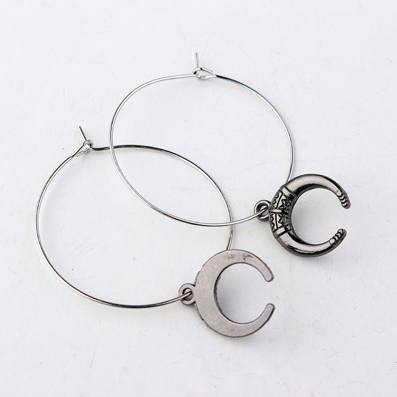 A high-quality European And American Gothic Moon Hoop Punk Exaggerated Black Horns Pagan Earrings woman with silver makeup and hoop earrings.