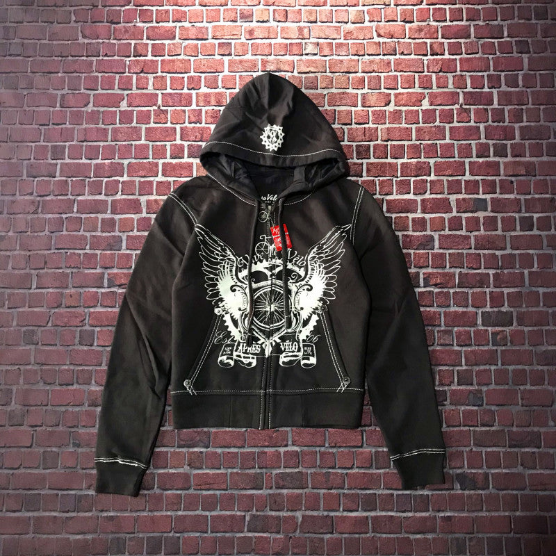 A loose fit, black Maramalive™ Hooded Sweater Motorcycle Heavy Metal Punk Can Take Lovers with a front zipper and graphic design of winged hearts and crowns, displayed against a brick wall background.