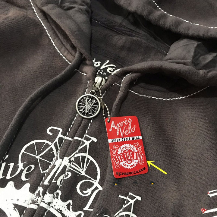 Close-up of a loose fit black Hooded Sweater Motorcycle Heavy Metal Punk Can Take Lovers with a zipper featuring a silver bicycle pendant, a red tag with white text "Maramalive™," and a yellow arrow pointing to "Live the Ride!".