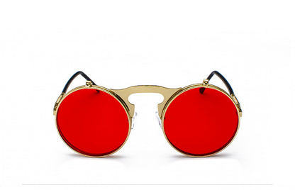 A pair of Maramalive™ Retro Metal Steampunk Flip Sunglasses Round Frame sitting on top of a pink surface.