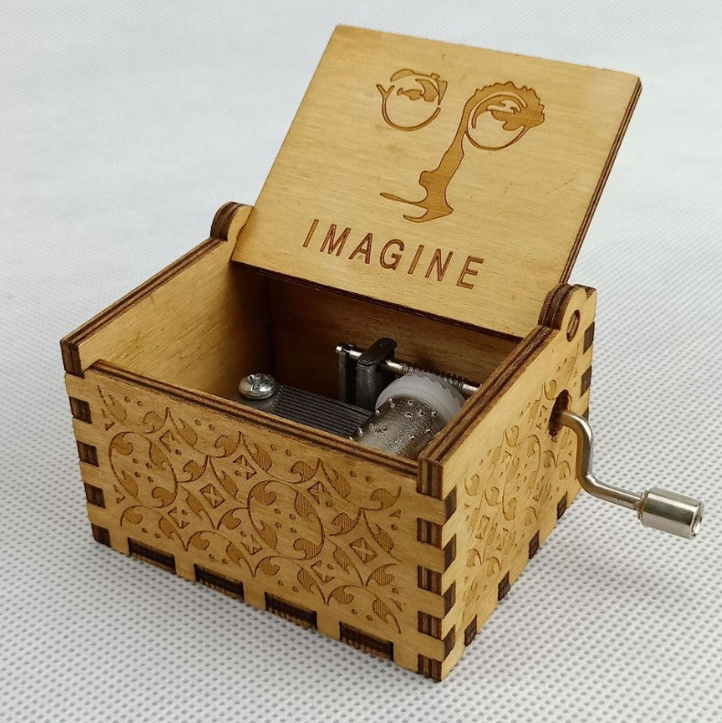 An Antique Carved Wooden Hand Crank Music Box with the word queen on it, made by Maramalive™.