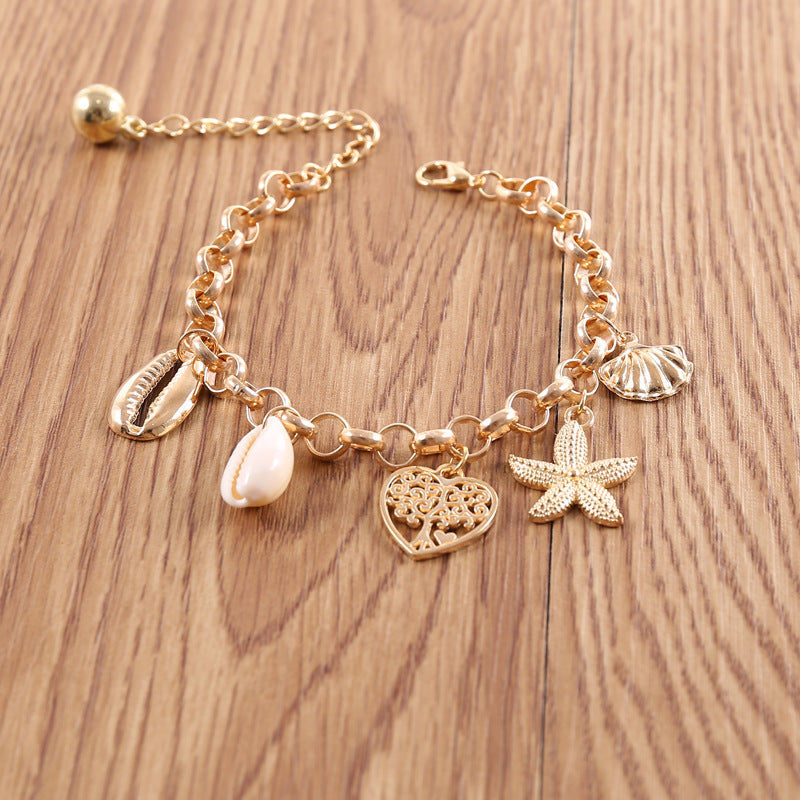 A woman wearing a Maramalive™ Women's Fashion Simple Shell Starfish Scallop Love Bracelet.