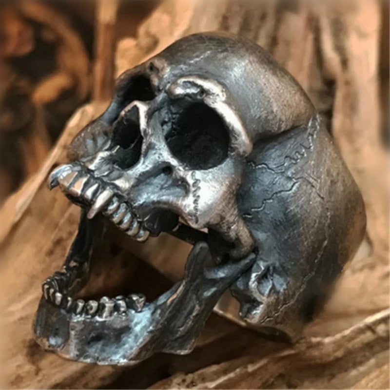 A Gothic Skull Punk Ring by Maramalive™ on a piece of wood.