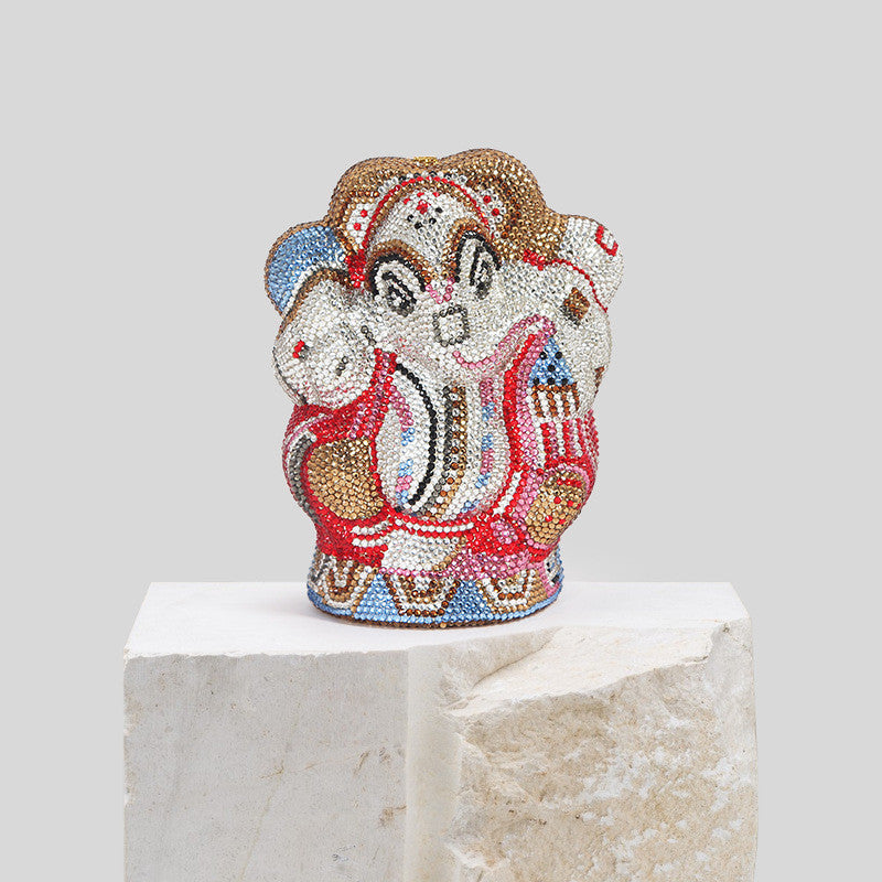 A Women's Handmade Diamond Elephant Shaped Clutch Chain Bag by Maramalive™ sits on top of a stone.
