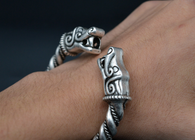 A Dragon Twisted Bracelet with a viking head on it by Maramalive™.