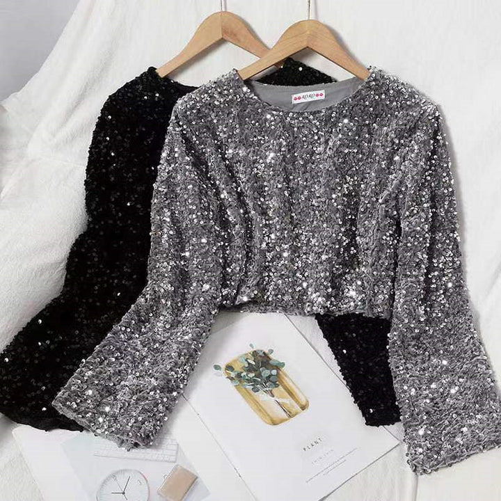 A fashionista's bed adorned with two Shimmery Sequined Crop Tops for dazzling style, including a luxurious Maramalive™ Cashmere Sequined Crop Top.