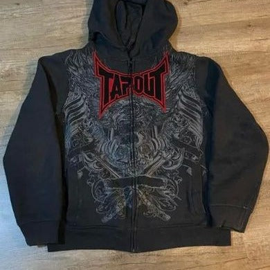 A black Men's Skeleton Zipper Hooded Sweatshirt with a front zipper, featuring a red "Tapout" logo and intricate grey designs on the front. This Maramalive™ hoodie adds an edgy twist with gothic skeleton prints that seamlessly blend punk rock style into your wardrobe.