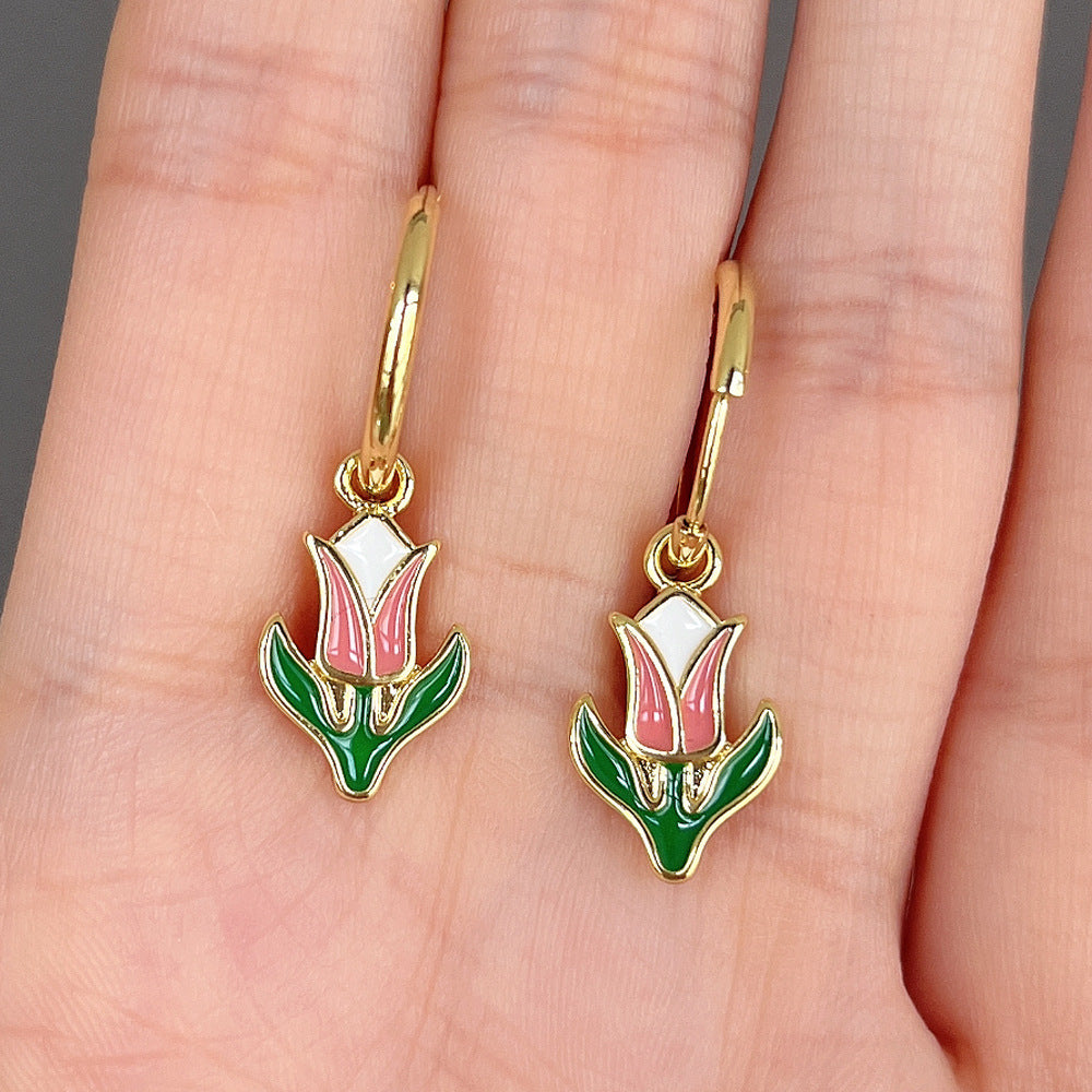 A hand holding a pair of Maramalive™ Contrasting Earrings.