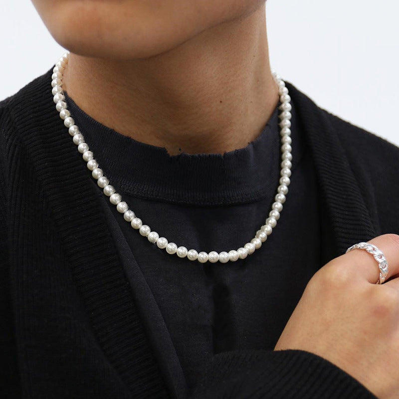 Three Maramalive™ white pearl necklaces on a black surface.