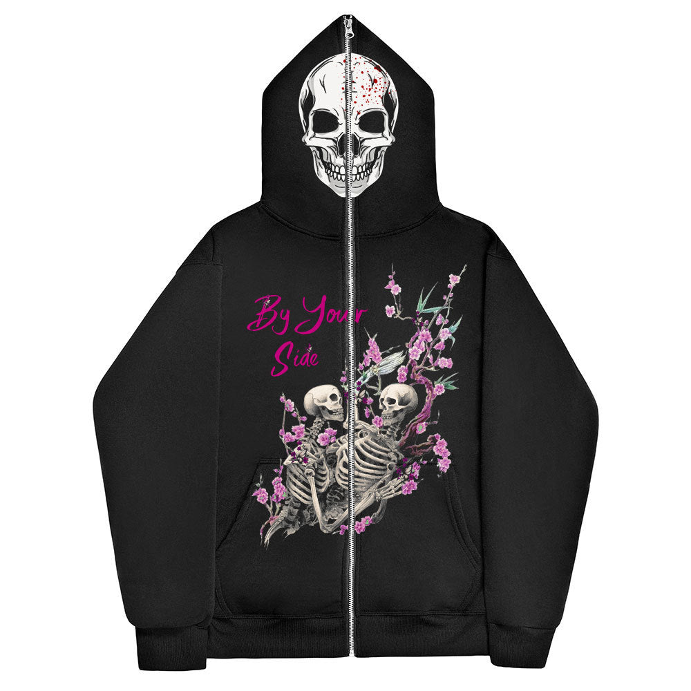 Black Gothic Zipper Sweater: The Perfect Gothic Top Multi-colors by Maramalive™ with a skull printed on the hood and an illustration of two intertwined skeletons surrounded by pink flowers on the back. The text "By Your Side" is above the skeletons in pink, adding a Gothic style touch.