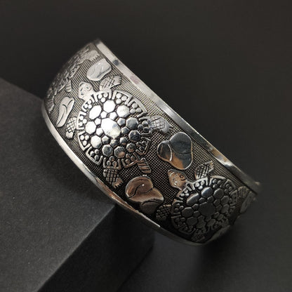 A Vintage Tibetan Elephant Jewelry bracelet with flowers and leaves on it, by Maramalive™.