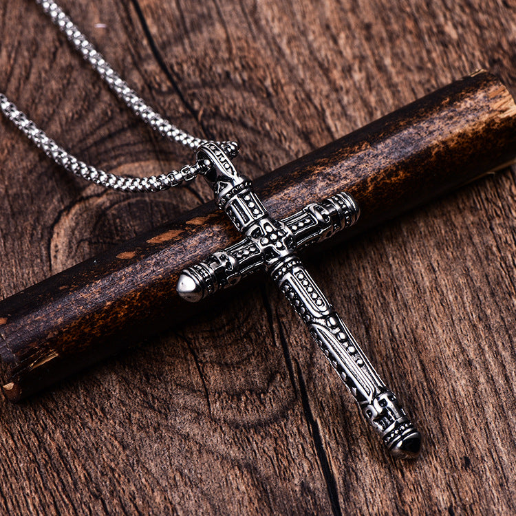 Punk Style Titanium Vintage Cross Pendant Necklace placed on a piece of wood with a wood background