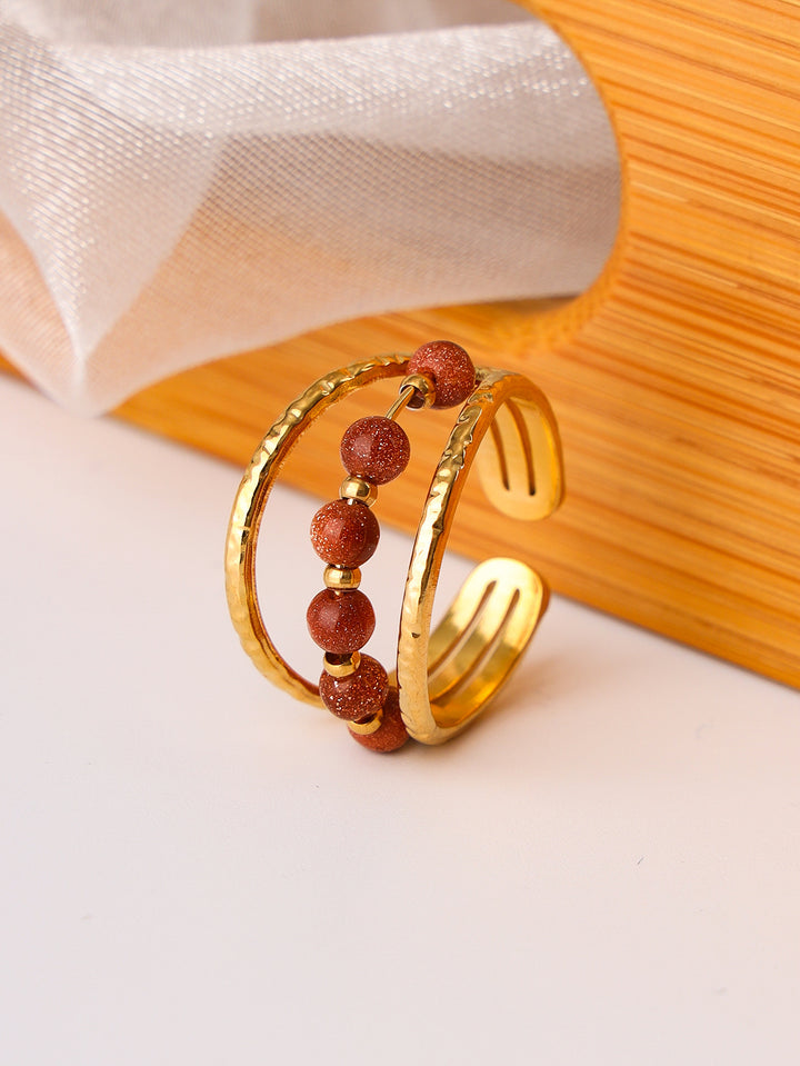 A Maramalive™ gold plated ring with turquoise beads.