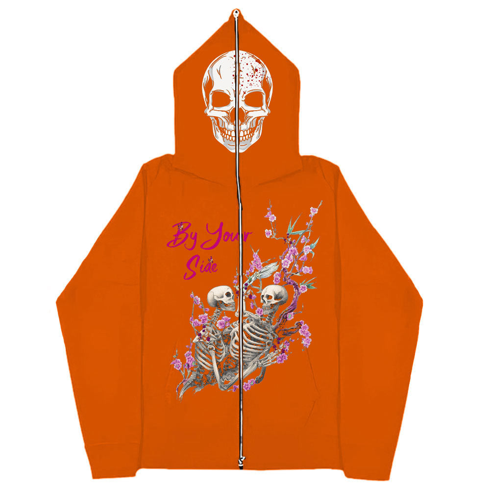 A Gothic Couple Harajuku Black Sweatshirt Zipper Sweater by Maramalive™ featuring a skull graphic on the hood and an illustration of two skeletons with pink flowers and text reading "By Your Side" on the back.