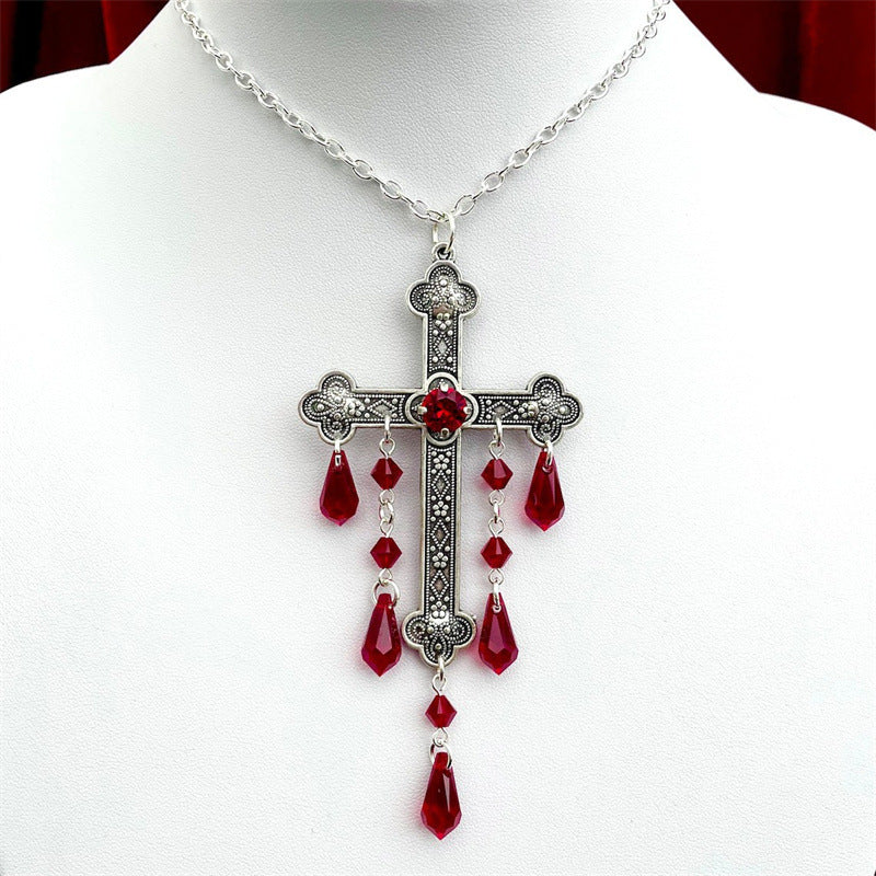 A hand is holding a Maramalive™ Large Cross Necklace Choke Gothic Pendant on a mannequin, exhibiting a dark style.