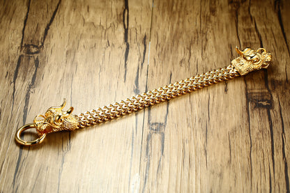 A Maramalive™ Titanium steel men's golden dragon head bracelet with two dragons on it.