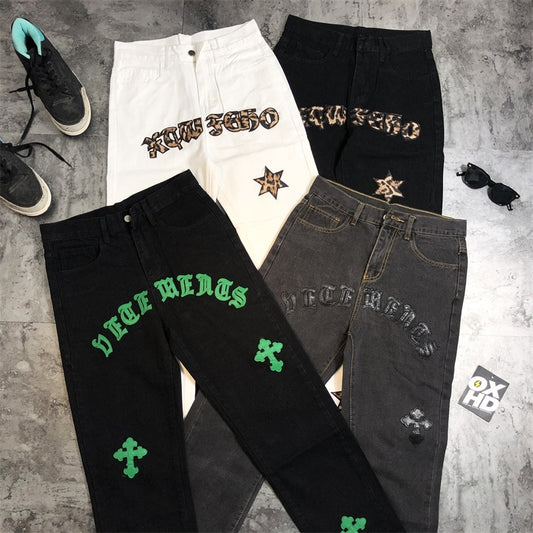 Four pairs of Super High Pants Leather Gothic Letters cross Men's Jeans by Maramalive™ with different designs, including gothic lettering and untamed denim.