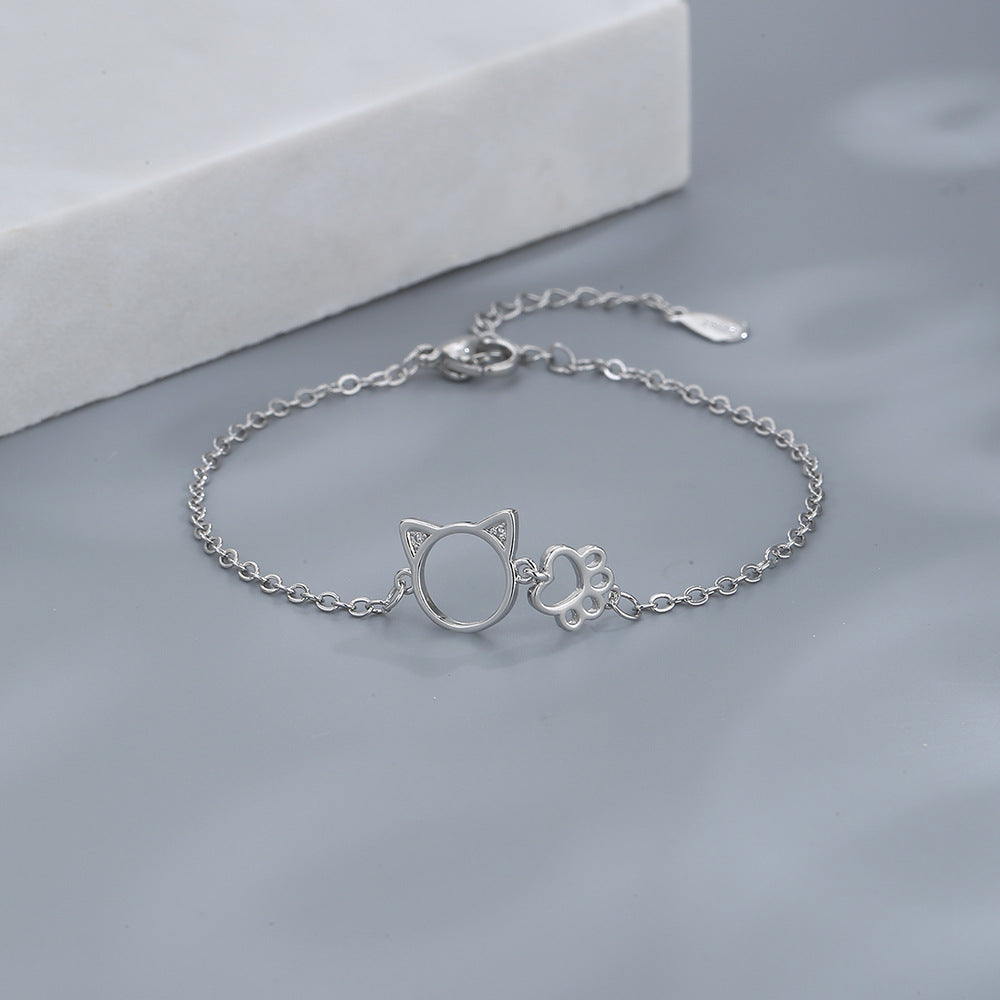 A woman wearing a Maramalive™ Minimalist Sparkling Diamond Bracelet with an initial on it.