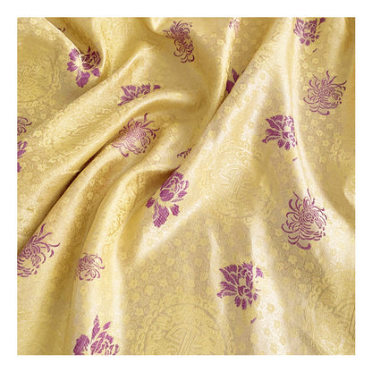 A Maramalive™ yellow and purple fabric with flowers on it.