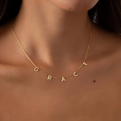 A woman wearing a Maramalive™ Personalized Alphabet Name Necklace DIY Choose your Name Letters with the word grace on it.