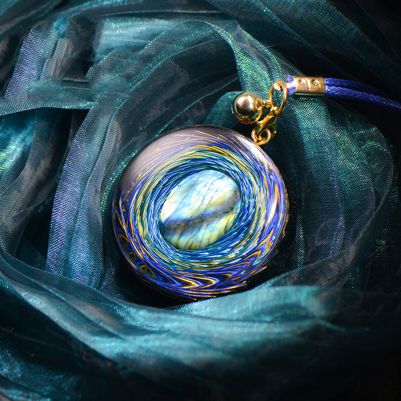 A blue cloth with a High Frequency Natural Crystal Pendant Votive Necklace from Maramalive™ on it.