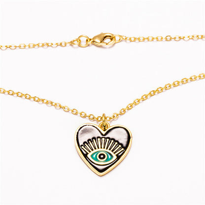 A black and green Demon Eye Necklace with a gold chain from Maramalive™.