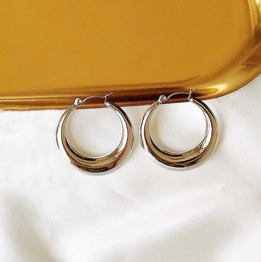 Luxury earrings by Maramalive™ on a gold tray.