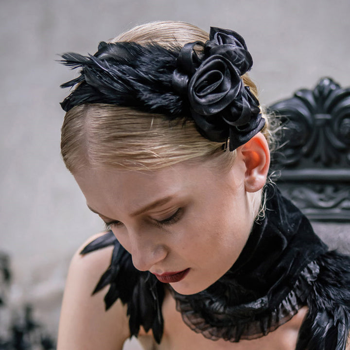 A woman wearing Gothic Flower Hair Clips in a black feathered headband from Spooky Locks Accessories by Maramalive™.
