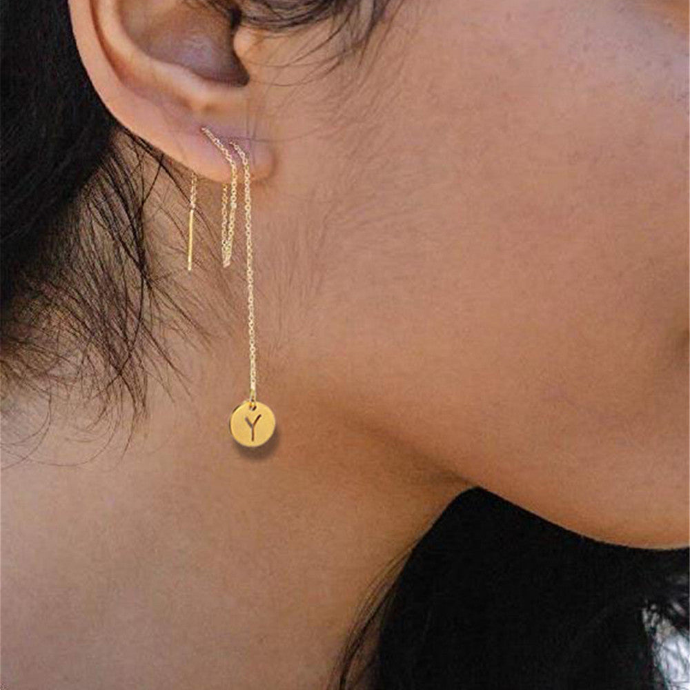 A woman wearing a pair of Maramalive™ Temperament Long Stainless Steel Earrings.