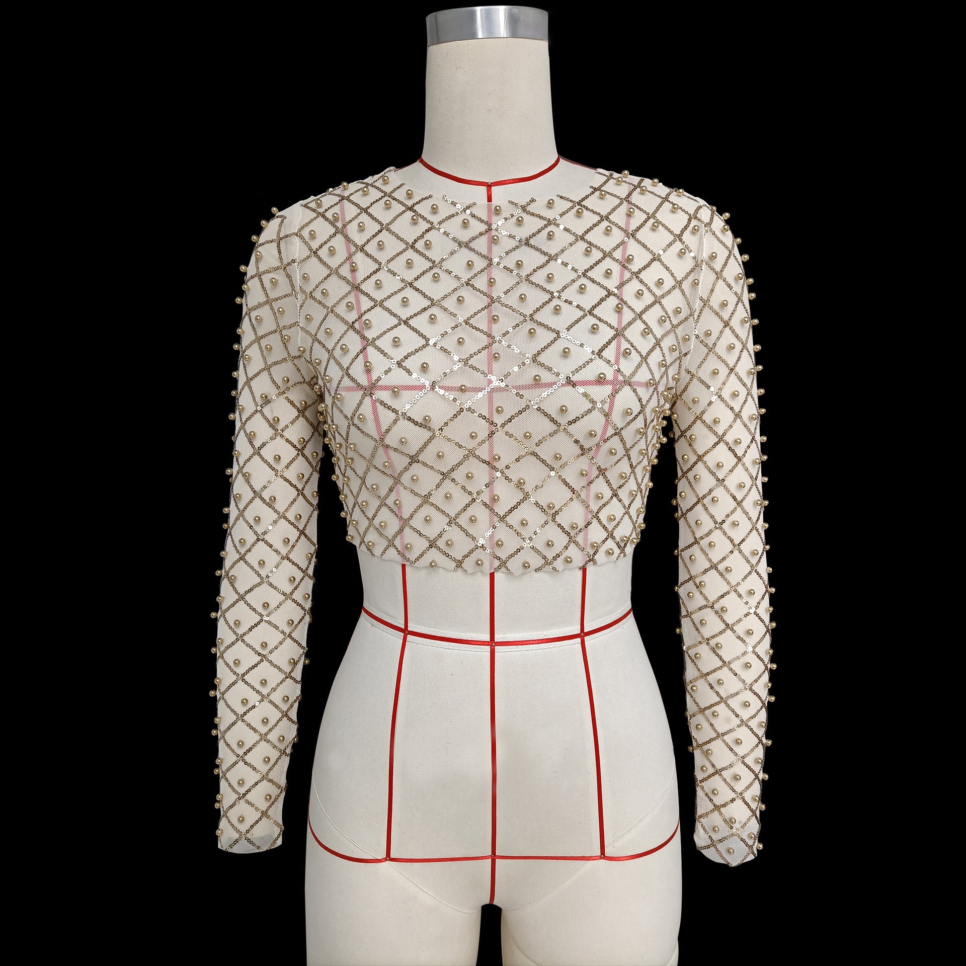 A mannequin wearing the Maramalive™ Mesh Studded Sequin Long-sleeved Shirt showcases celebrity style. Made of polyester fiber, the top exudes elegance. The mannequin is marked with red lines to indicate measurements.
