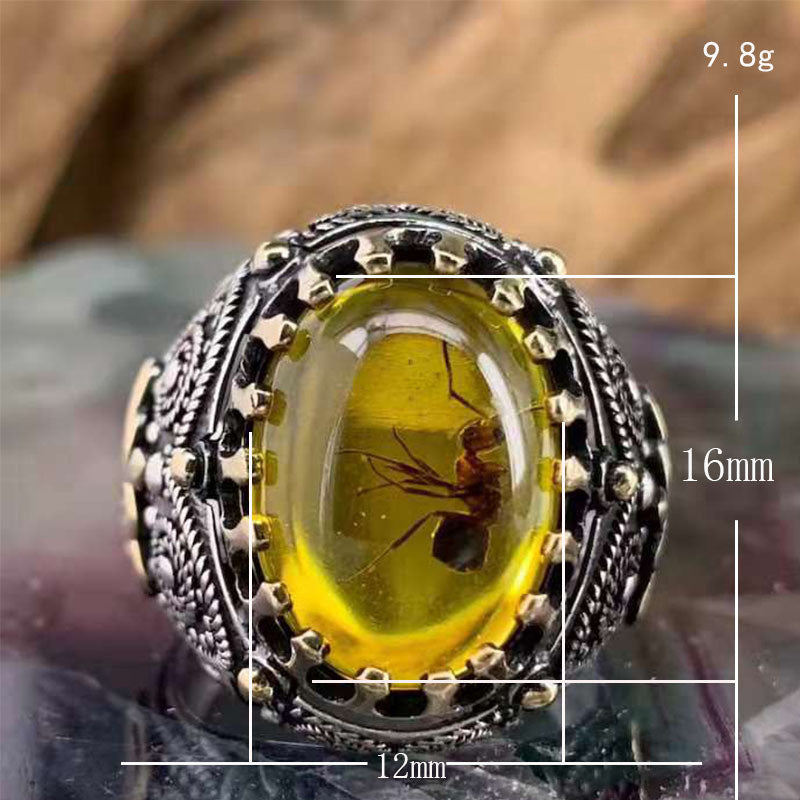 A Retro Two-color Men's Black Agate Ring with a yellow amber stone.