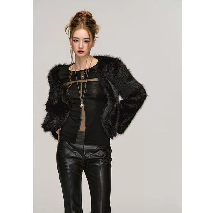 A person stands against a plain background, exuding pure desire style in a Maramalive™ Fashion Long Sleeve Bottoming Shirt For Women and black leather pants, complemented by layered necklaces. Their hair is styled up, adding a chic touch to the ensemble.