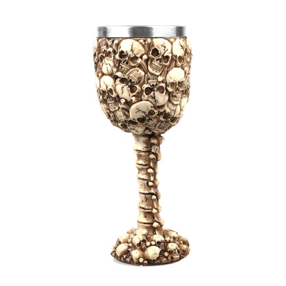 A Personalized Resin Skull Wine Glass by Maramalive™ sitting on a desk.
