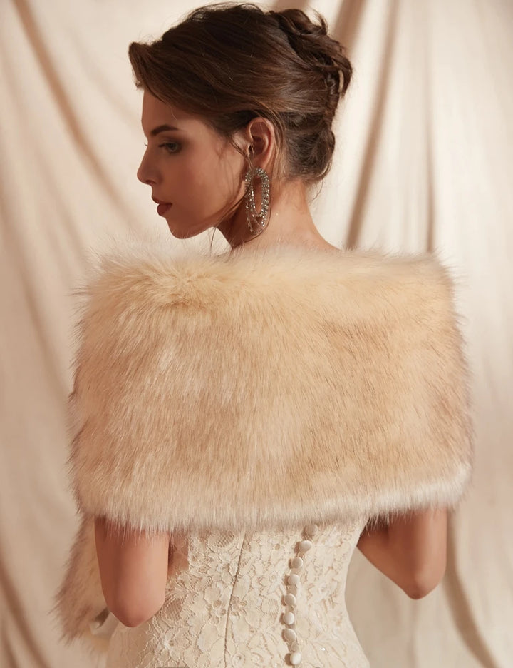 A woman in an elegant lace dress and a 30 colors Women Fur Capes Champagne Wedding Bolero Faux Fur Stole Bridal Jacket Formal Party Shrug Walk Beside You De Mariage by Maramalive™, her hair styled up, is seen from the side and back. She wears large, dangling earrings that complement her wedding dress accessories beautifully.