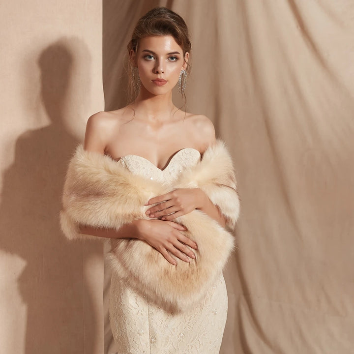 A woman in a strapless lace gown and a Maramalive™ 30 colors Women Fur Capes Champagne Wedding Bolero Faux Fur Stole Bridal Jacket Formal Party Shrug Walk Beside You De Mariage stands against a beige backdrop, showcasing elegant wedding dress accessories.