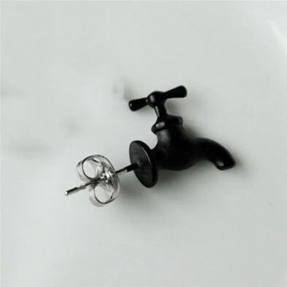 Silver and black punk faucet earring on ear