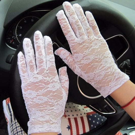 Women in black lace gloves in the car