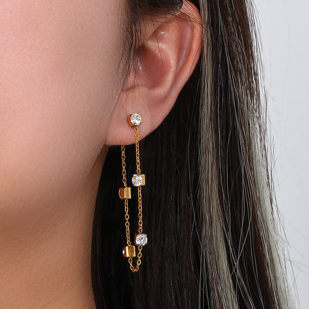 A woman wearing a pair of Maramalive™ Fashion Personality Fashion Ornament Stainless Steel Earrings with diamonds.