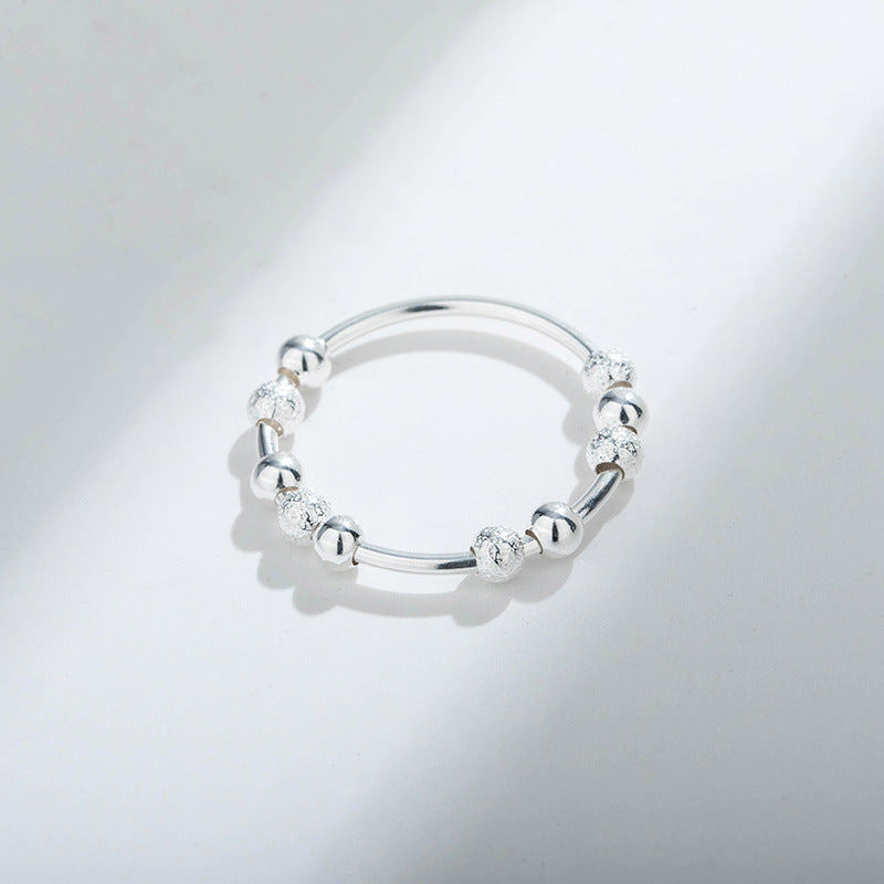 A woman's hand with a Maramalive™ Women's Stylish And Simple Personality Sterling Silver Anxiety Ring on it.