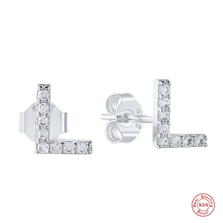 A woman wearing a pair of Maramalive™ Personalized Sterling Silver Letter Earrings with the word 'jebel' on them.