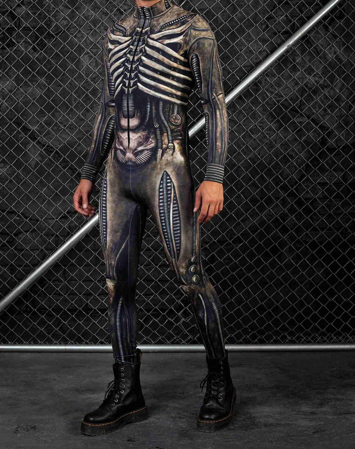 A person wears a Maramalive™ Halloween New Tights 3D Digital Printing One-piece Play Costume with an alien skeleton design, standing in front of a chain-link fence—a unique piece that blends street fashion sensibilities, available in both children and adult sizes.