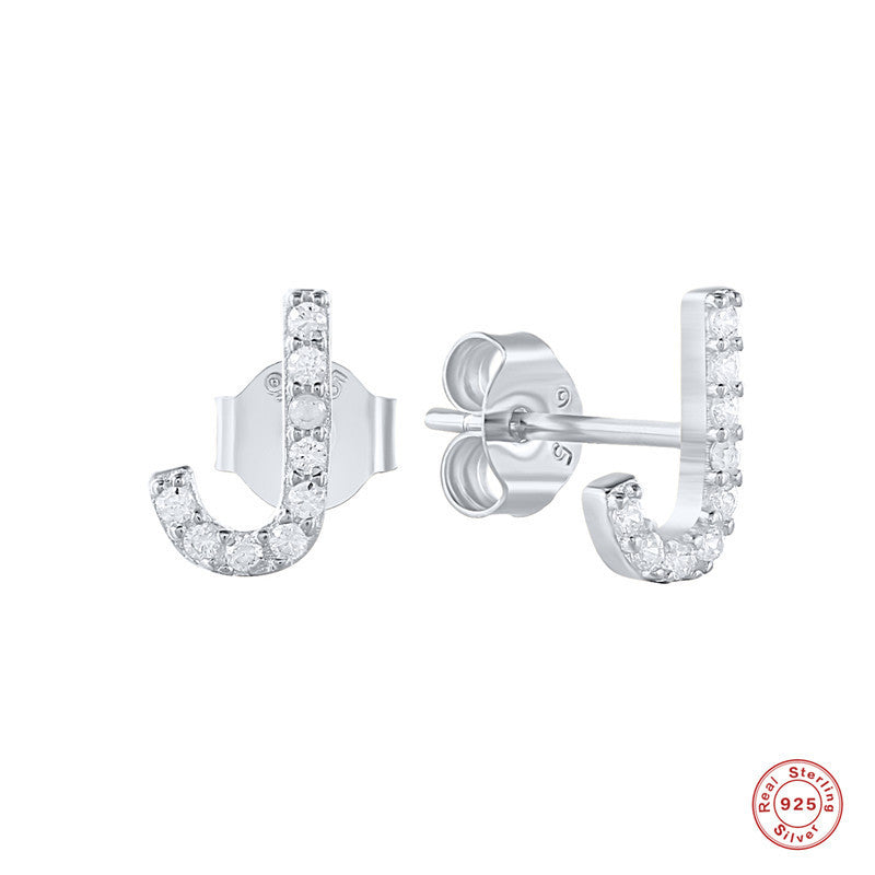 A woman wearing a pair of Maramalive™ Personalized Sterling Silver Letter Earrings with the word 'jebel' on them.
