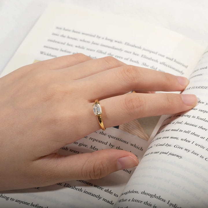 Moissanite Gold plated Silver ring, Emerald Cut setting with Gold accents, diamond accents. on a models hand