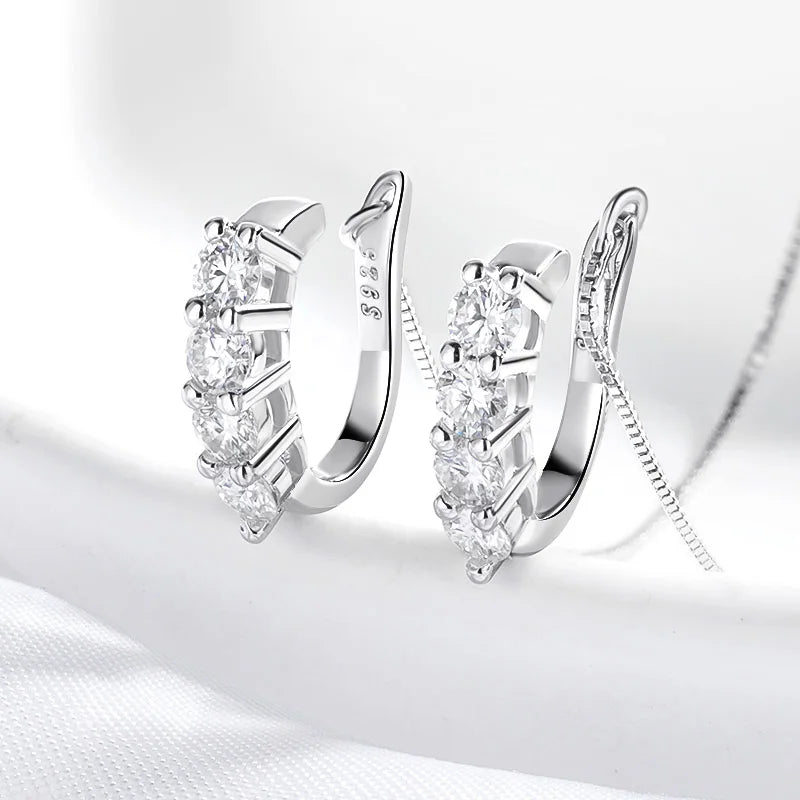 Luxury Moissanite Earrings sparkling on a lit white background. 
