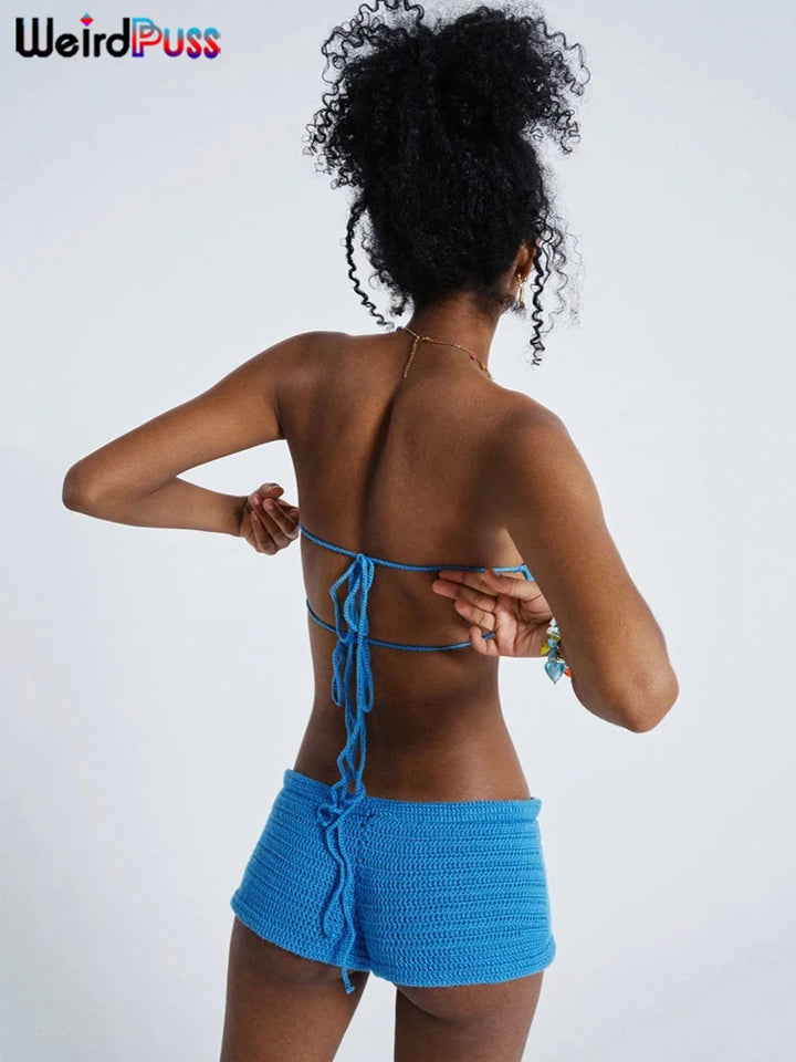 A person is standing with their back to the camera, wearing a blue Maramalive™ Embroidery Women 2 Piece Set Knit Summer Vacation Backless Bandage Strapless Tops+Shorts Casual Matching Slim Outfits, adjusting the strings of the top.
