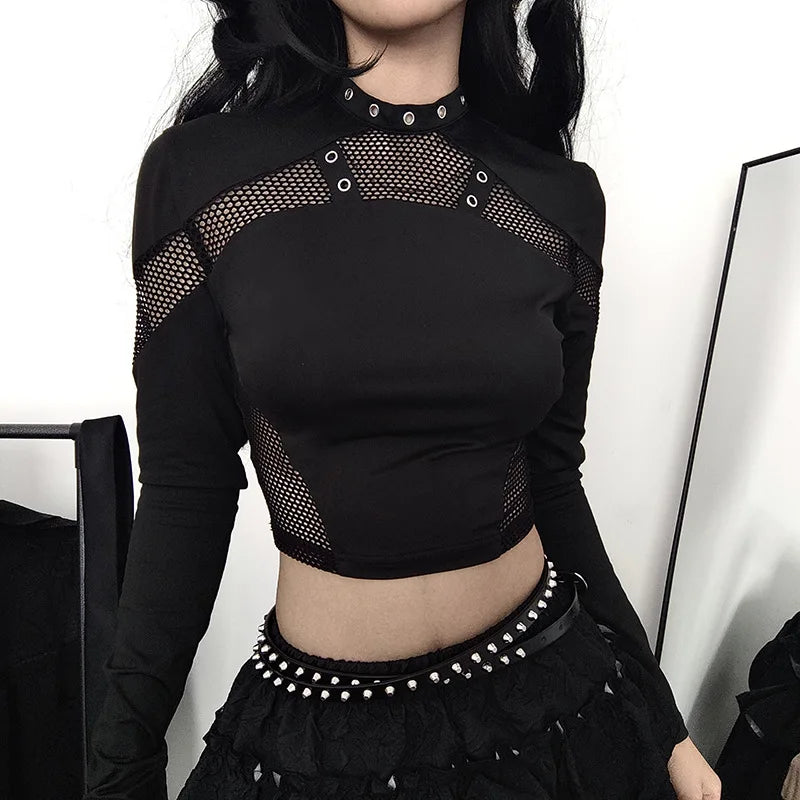 Person wearing a Maramalive™ Goth Dark Techwear Cyber Gothic Fishnet Patches T-shirts Punk Grunge Hollow Out Skinny Crop Top Black Eyelet Fashion Alt Clothe, paired with a black skirt adorned with a studded belt, epitomizing Goth Dark streetwear style.