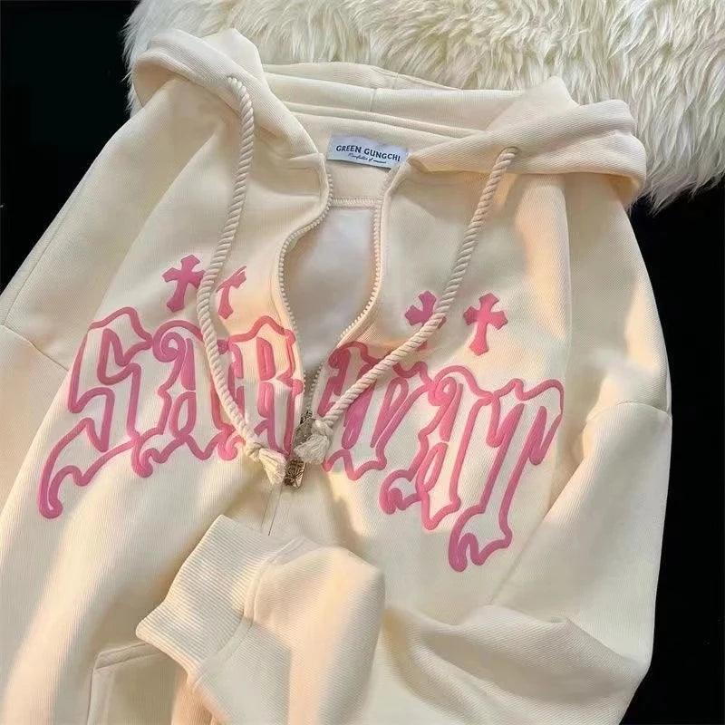 Maramalive™ Goth Embroidery Hoodies Women High Street Retro Hip Hop Zip Up Hoodie Loose Man Sweatshirt Hoodie Clothes Y2K Hoodie with the word "Savior" in pink Gothic lettering on the front, featuring a white drawstring hood and a zipper. It is laid out on a fur-covered surface, perfect for streetwear enthusiasts.